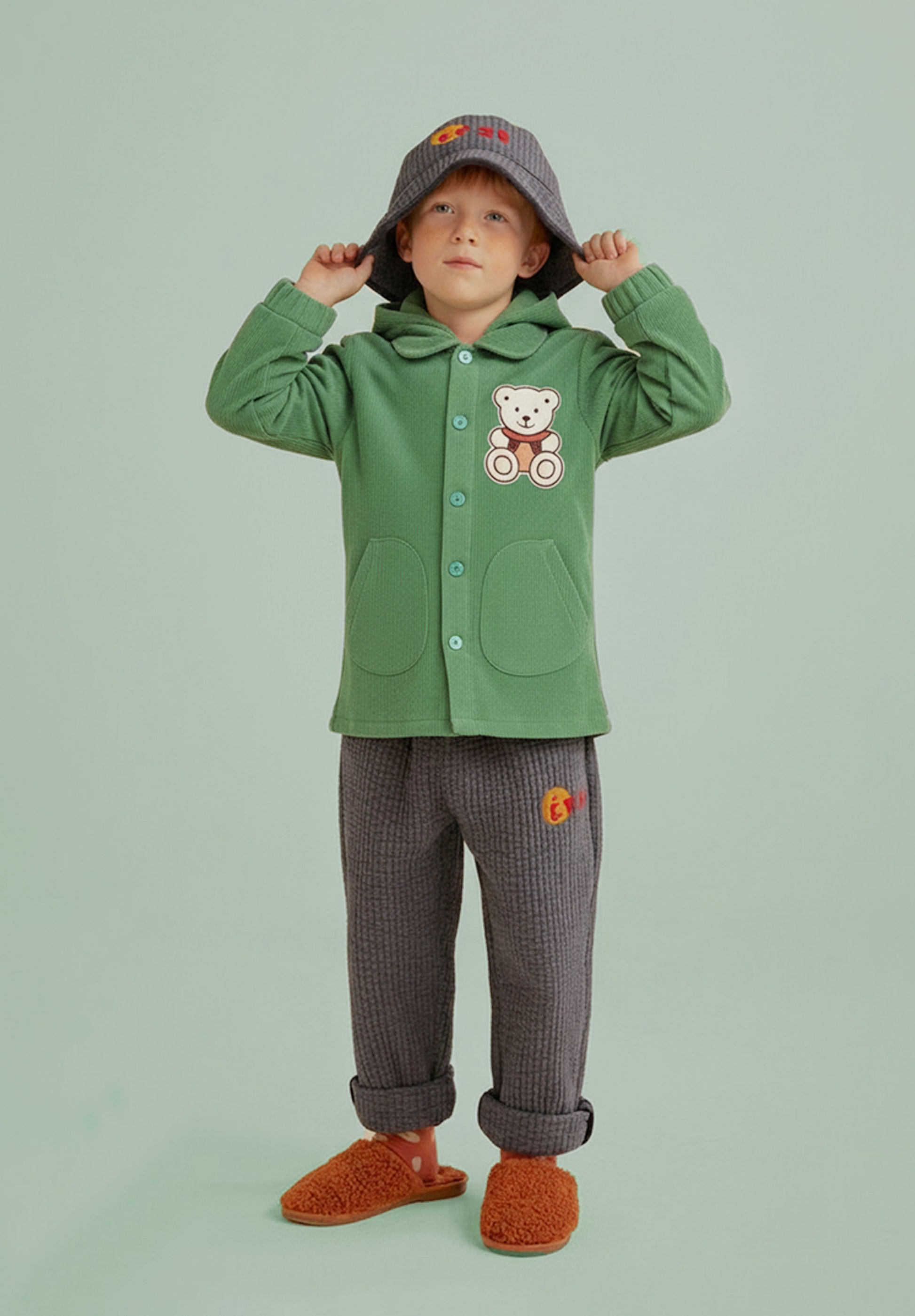 Green children's jacket with a teddy bear patch on a white background., jacket for children