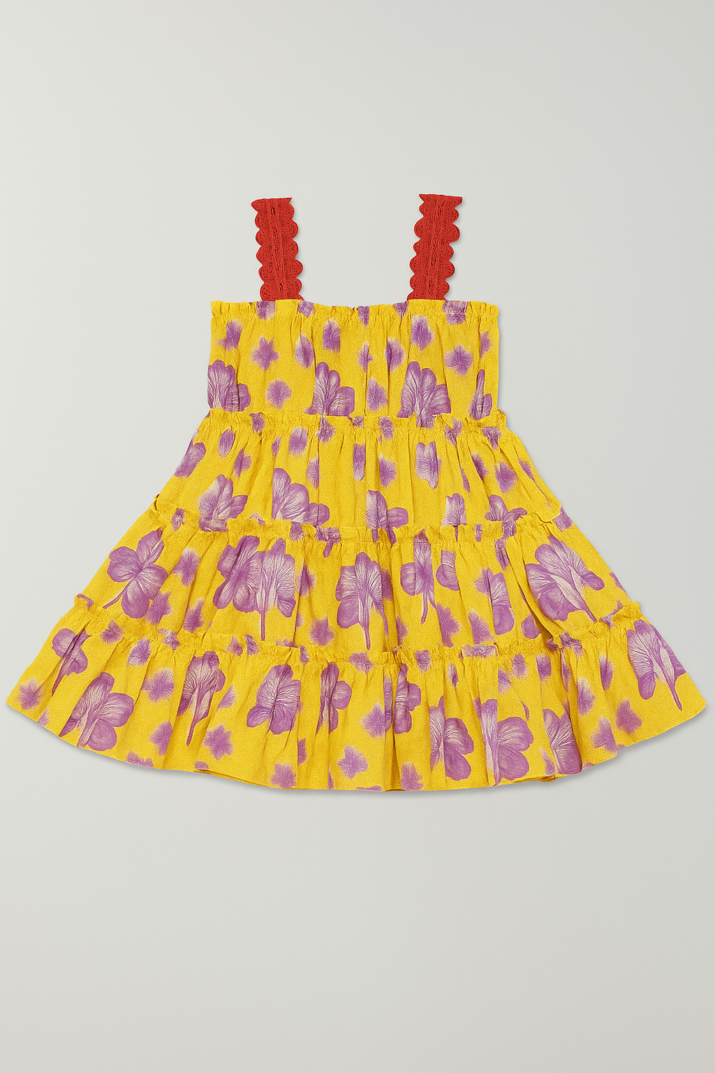 Yellow dress with purple floral pattern and red straps on a light gray background